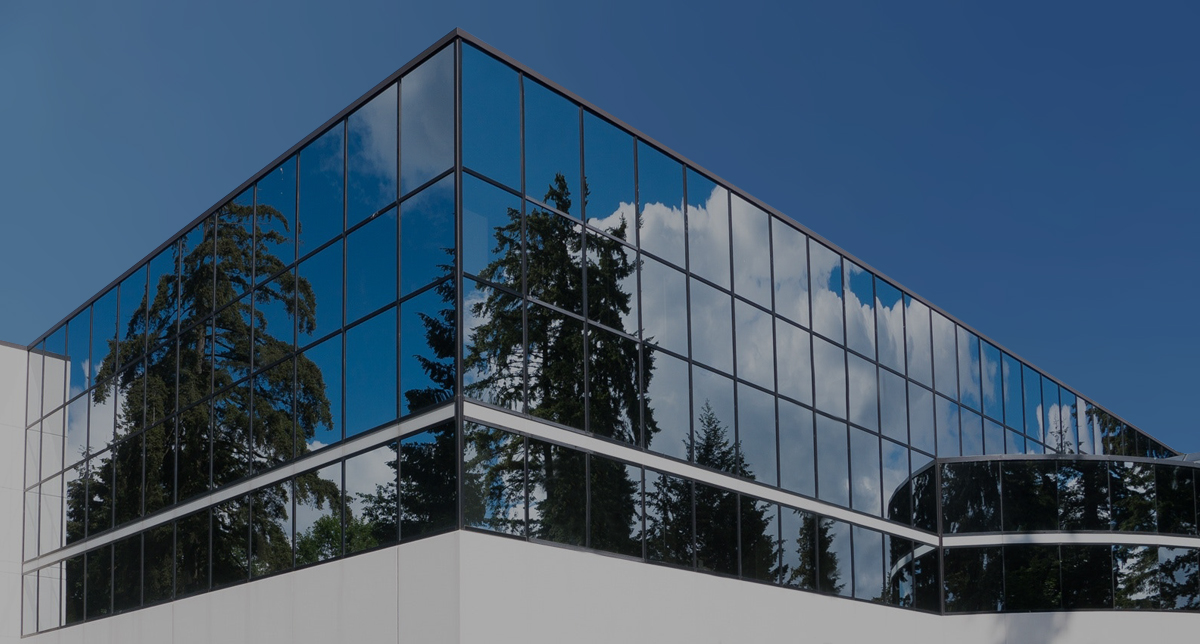 Glass office building reflecting natural settings